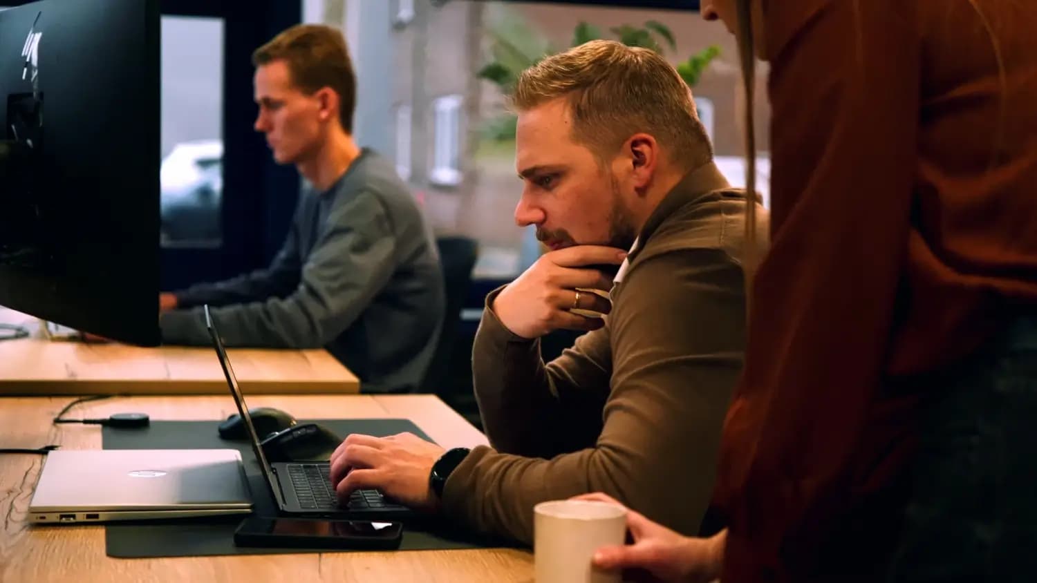 Marketingteam werkt geconcentreerd aan website op laptop